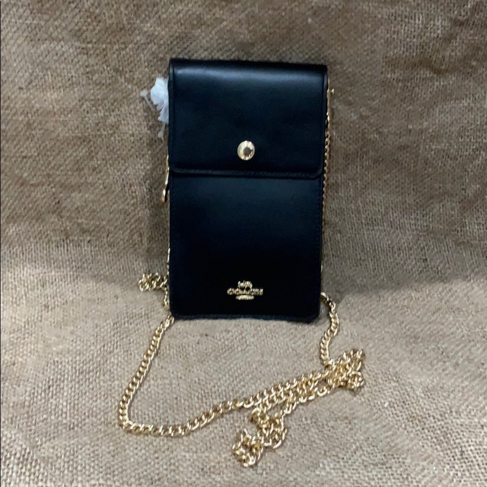 Brand new Coach black bag with tags. Minor dents